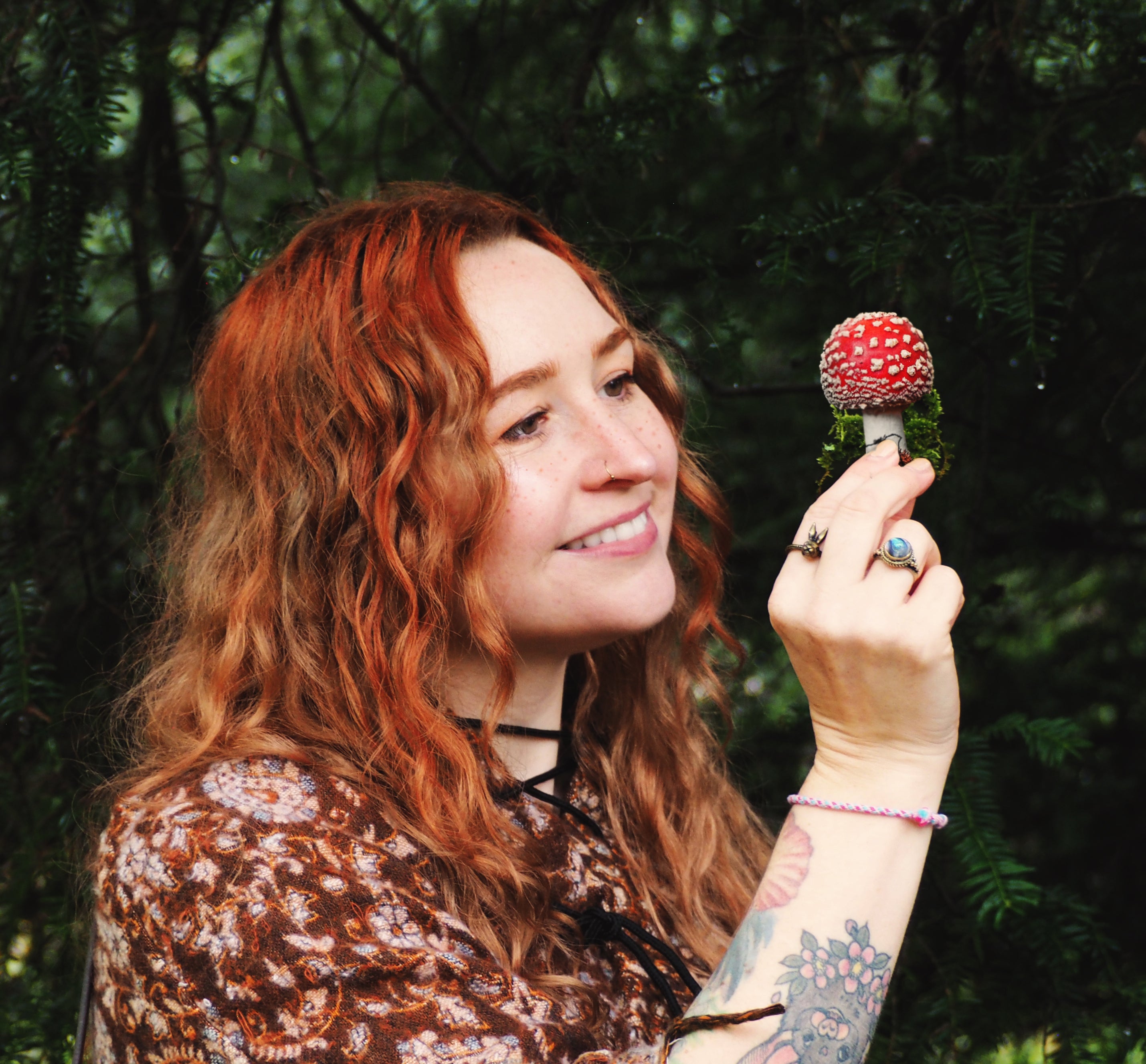 Naomi Joy with ginger hair, holding a mushoom. This is her main profile image and appears across her branding.